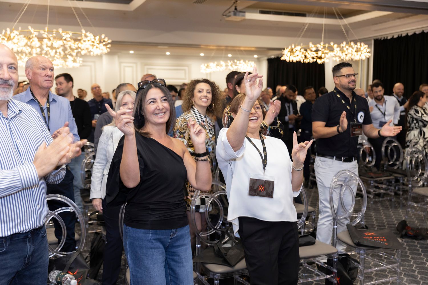 Audience applauding after a leadership keynote by Dr. Stephen Crawford
