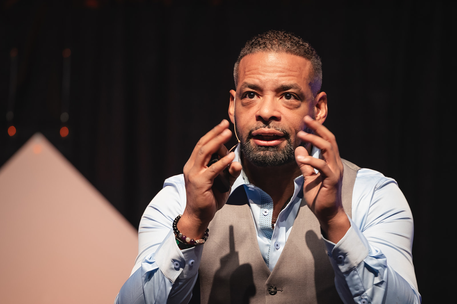 Dr. Stephen J. Crawford speaking on stage, hands raised in expression