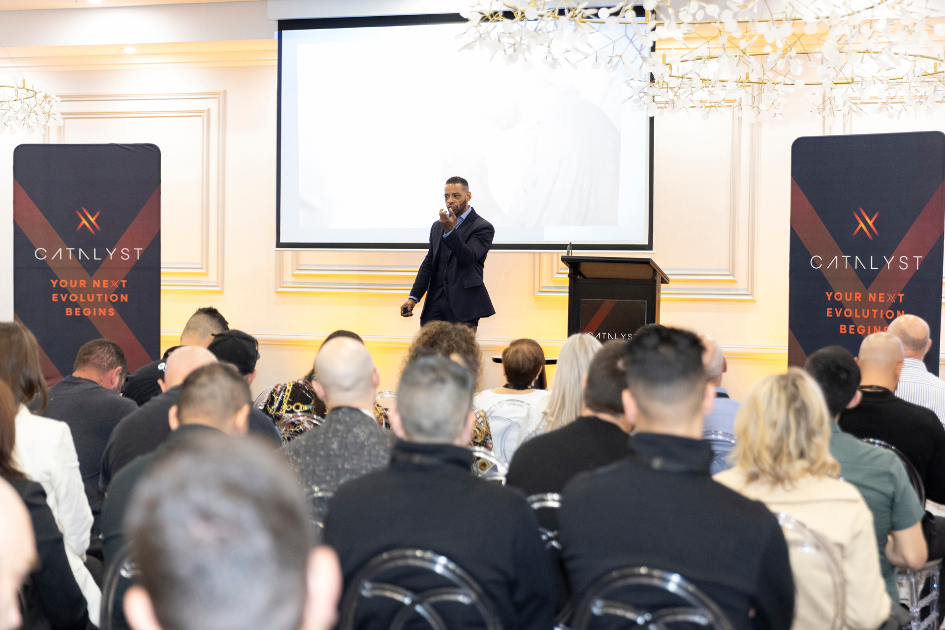 Dr. Stephen Crawford speaking on stage to a seated audience at a leadership keynote event.